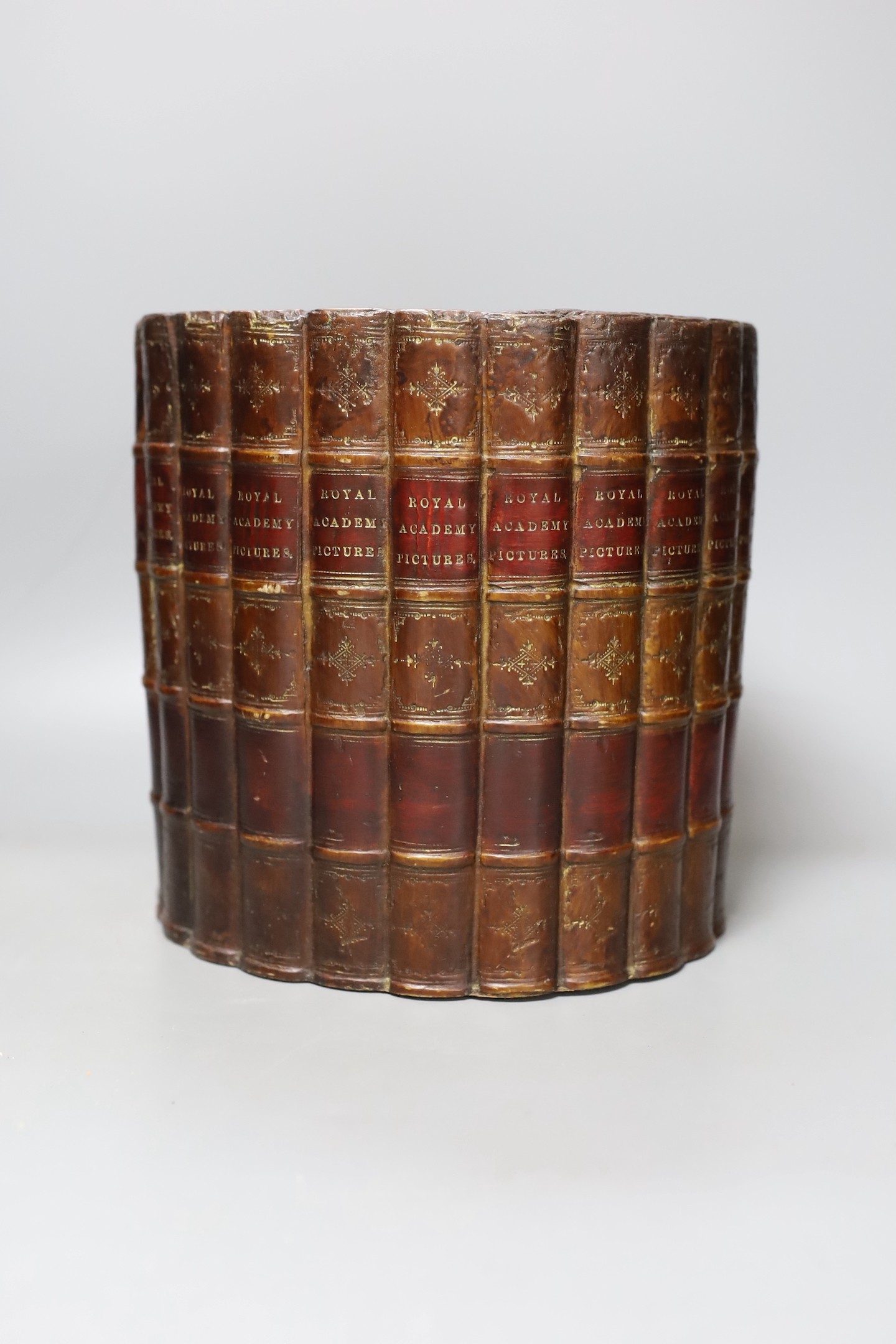 A ‘Royal Academy Pictures’ faux book spine waste paper bin, 22cm diameter.